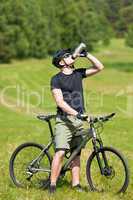 Sportive man mountain biking relax sunny meadows