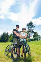 Sport mountain biking couple relax in meadows