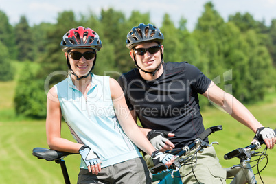 Sport mountain biking couple relax in meadows