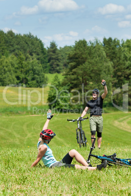 Sport mountain biking couple greeting in meadows
