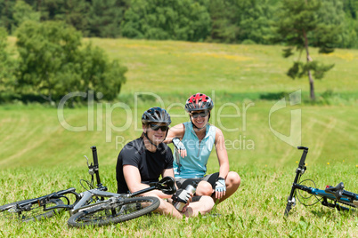 Sport mountain biking couple relax sunny meadows