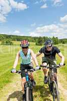 Sport mountain biking - man pushing young girl