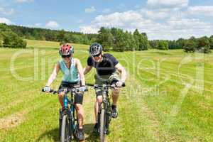 Sport mountain biking - man pushing young girl