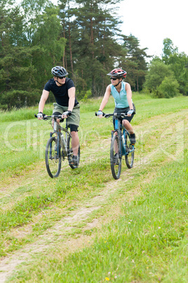 Sport happy couple riding bicycles in coutryside