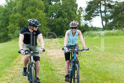 Sport happy couple riding bicycles in coutryside