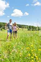 Sportive happy couple in meadows sunny day