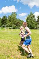 Sportive young couple jogging meadows sunny summer