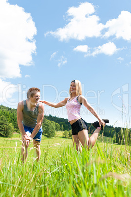 Sportive happy couple in meadows sunny day