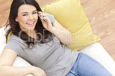 Happy Hispanic Woman Using Cell Phone At Home
