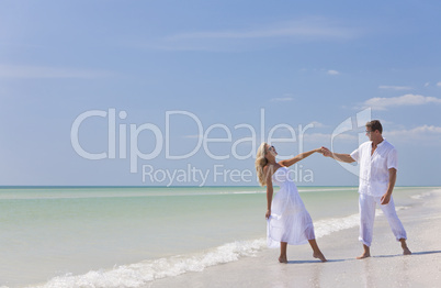 Happy Young Couple Dancing Holding Hands on A Tropical Beach