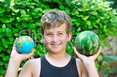 Boy with a watermelon and a globe