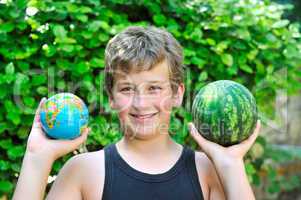 Boy with a watermelon and a globe