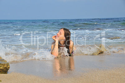 Girl lying in the sea waves