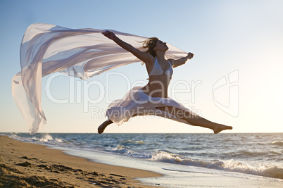 Woman jumping on the beach