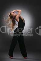 Frau tanzt im Studio, grauer Hintergrund