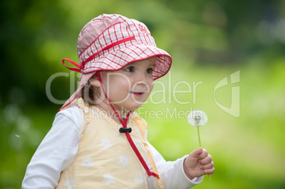 Little girl with blowball