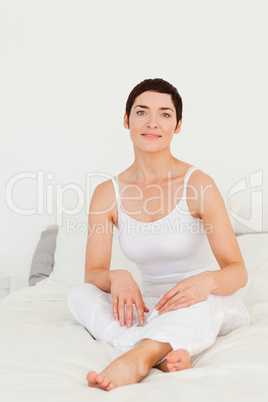 Woman sitting on her bed