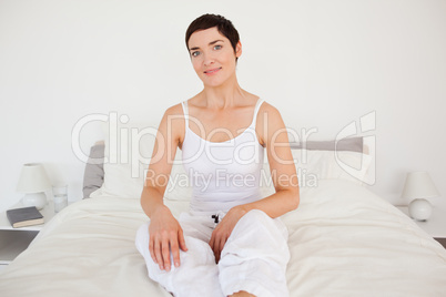 Lovely woman sitting on her bed