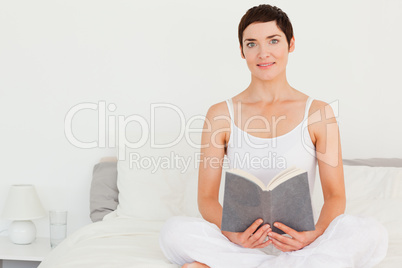 Lovely brunette holding a book