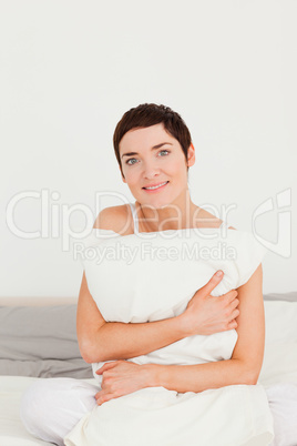 Portrait of a woman holding a pillow