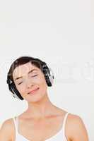 Portrait of a delighted woman listening to music