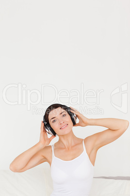 Portrait of a charming woman listening to music