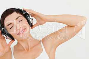 Close up of a lovely brunette listening to music