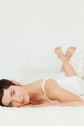 Portrait of a cute woman lying on her belly