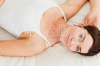 Close up of a charming woman lying on her back