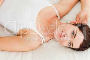 Close up of a charming woman lying on her back