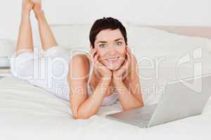 Woman posing with a laptop