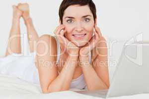 Close up of a woman posing with a laptop