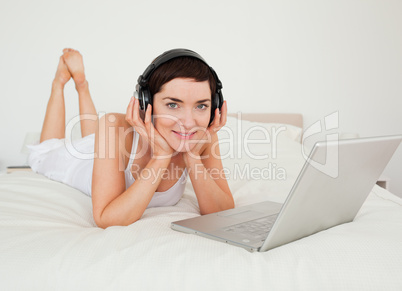 Woman listening to music with her laptop