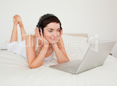 Young woman listening to music with her laptop
