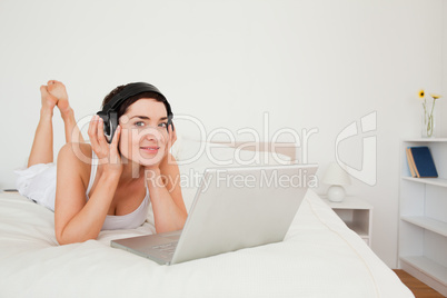 Cute woman watching a movie with her laptop