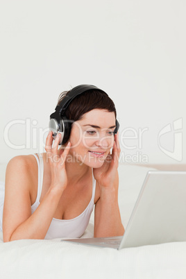 Portrait of a cute woman watching a movie with her laptop