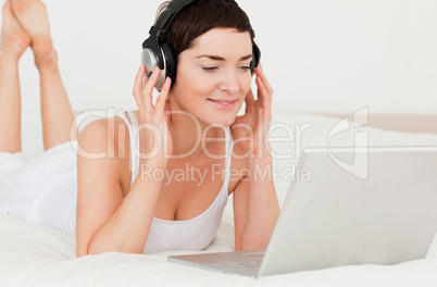 Close up of a cute woman watching a movie with her laptop