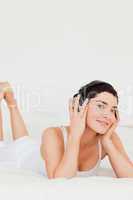 Portrait of a cute brunette listening to music