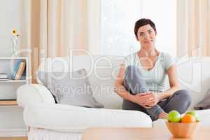 Cute woman sitting on a sofa