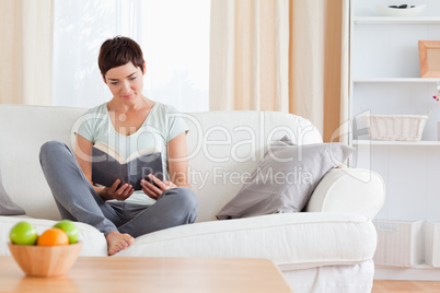 Lovely brunette reading a book