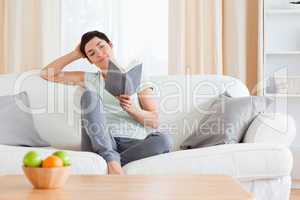 Cute woman reading a book