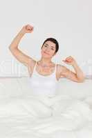 Portrait of a cute woman stretching her arms