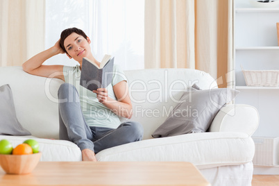 Cute brunette reading a book