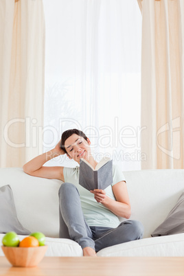 Portrait of a cute brunette reading a book