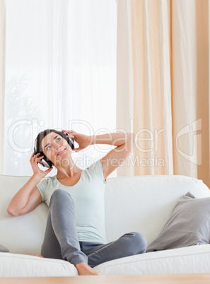 Portrait of a charming brunette enjoying some music