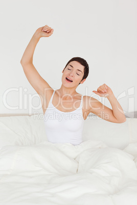 Portrait of a charming woman stretching her arms
