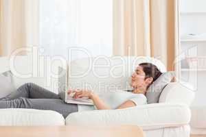 Young woman relaxing with a laptop