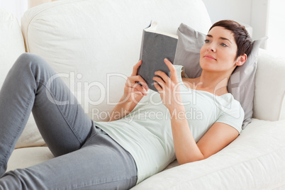 Beautiful brunette reading a book