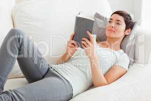 Beautiful brunette reading a book