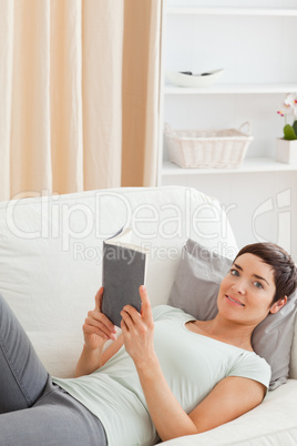 Portrait of a beautiful brunette holding a book